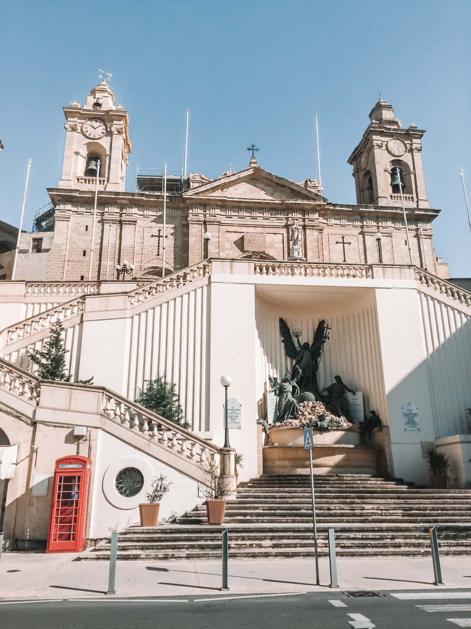 A church and a red phone booth in Birgu, Malta