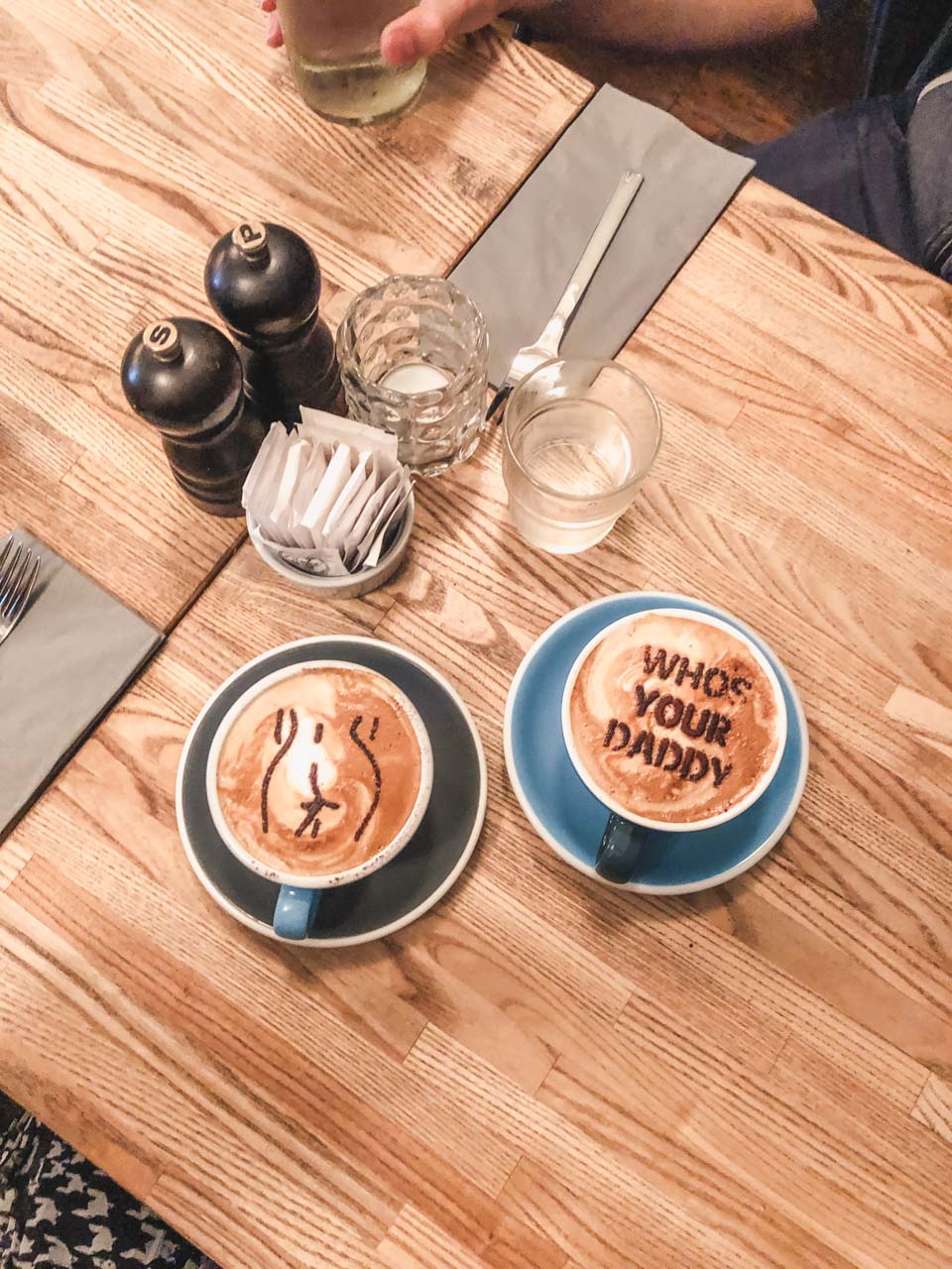 Two signature cappuccinos on a table inside The Union Kitchen in Copenhagen, Denmark
