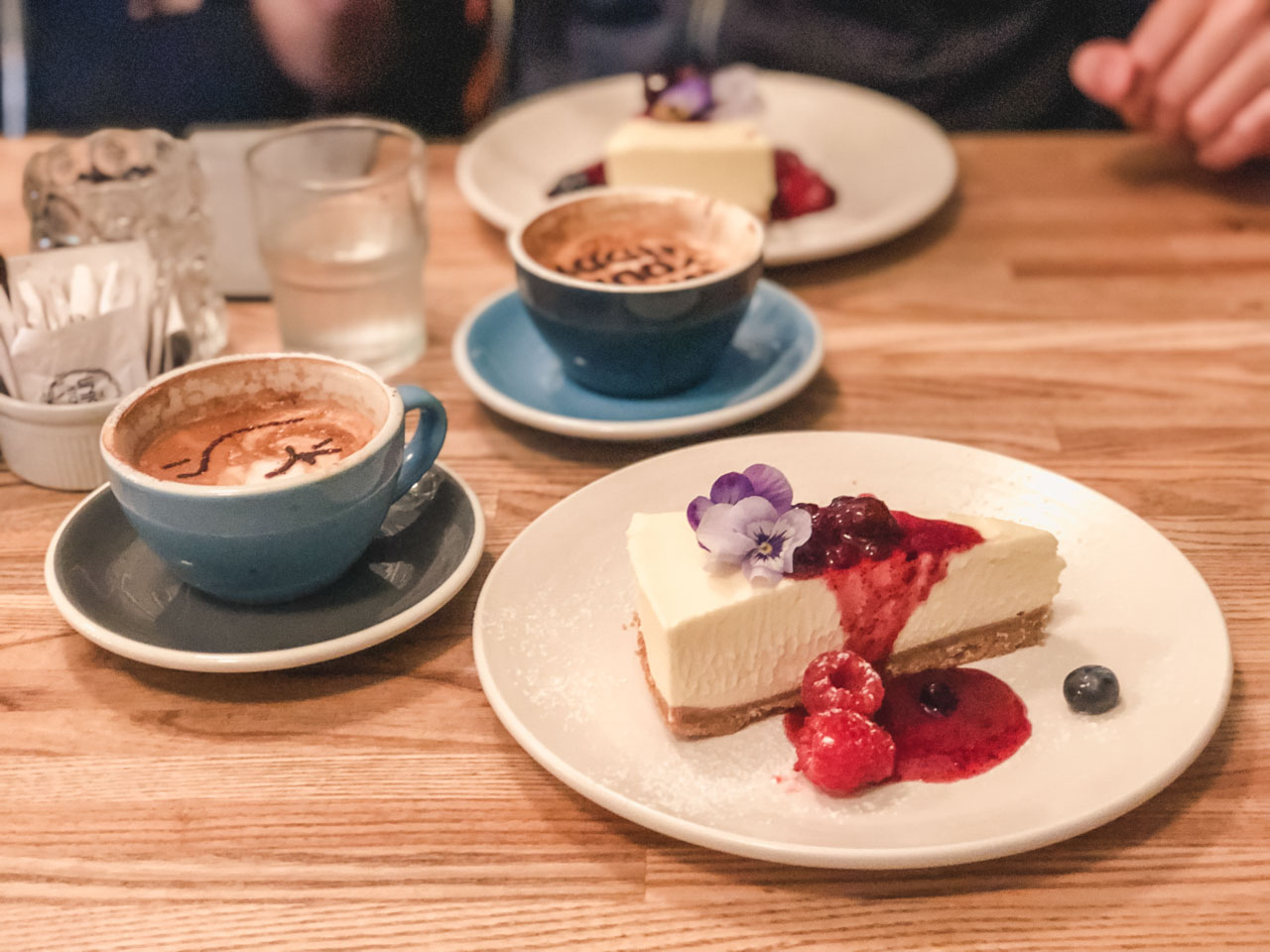 A cappuccino and a white chocolate cheesecake at The Union Kitchen in Copenhagen, Denmark