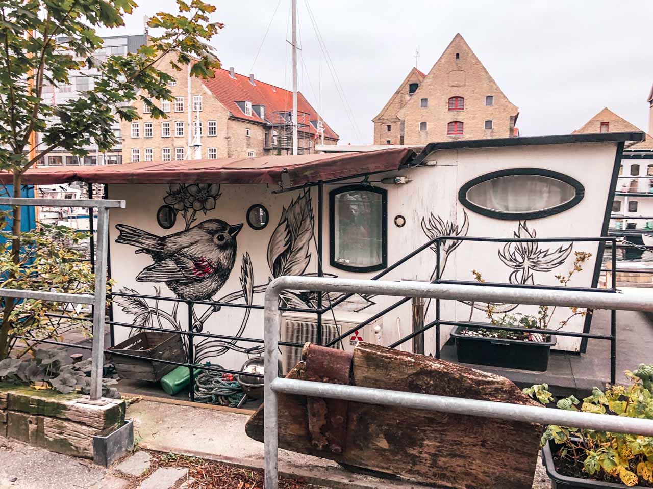 A boat with painted walls docked in the canal in Copenhagen, Denmark