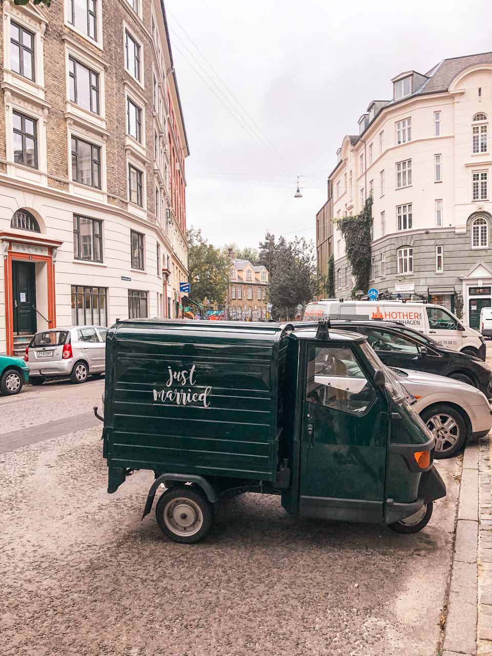 A tiny car with a 'just married' sticker on it parked on one of the streets in Copenhagen, Denmark