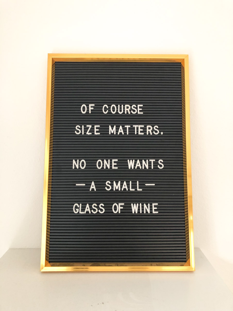 A funny sign that says Of course size matters. No one wants a small glass of wine