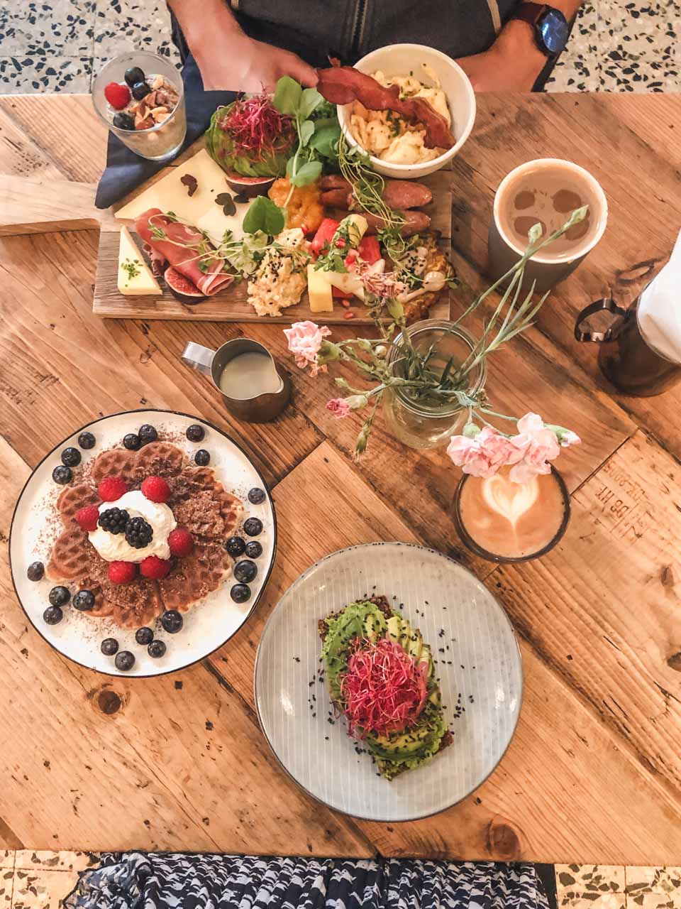 Avocado on rye bread, waffles and a breakfast plate