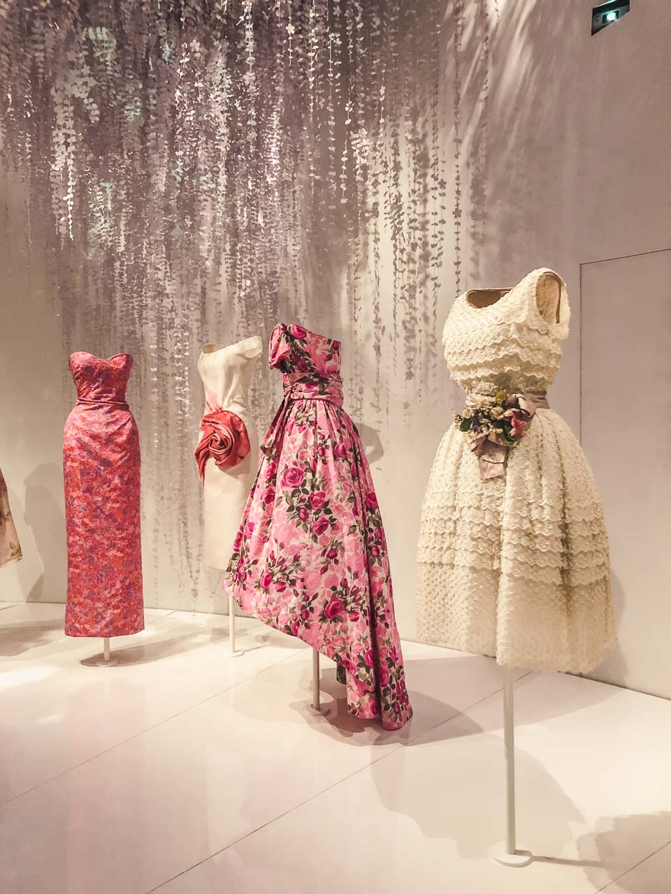 Dior gowns on display in the garden room of the Dior exhibition at the Victoria and Albert Museum in London
