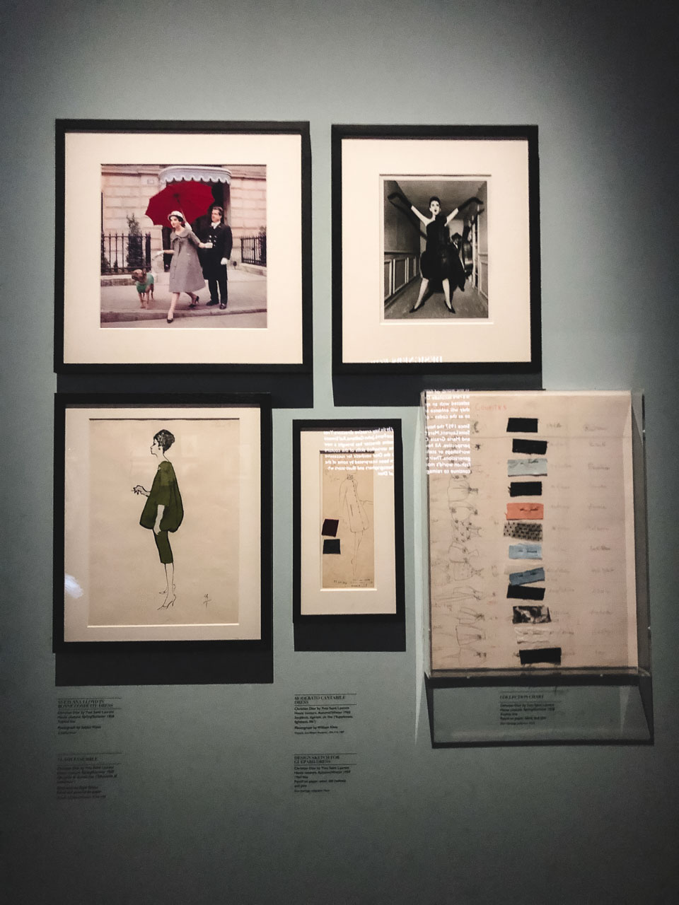 Photos of women wearing Dior dresses alongside Dior sketches and moodboards at the V&A Museum