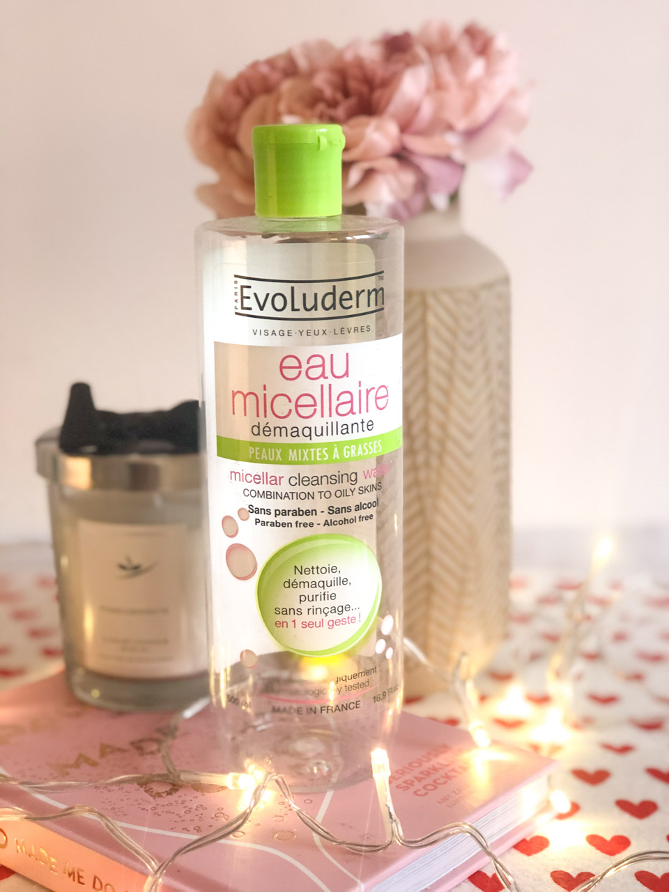 A bottle of Evoluderm micellar water standing on a desk