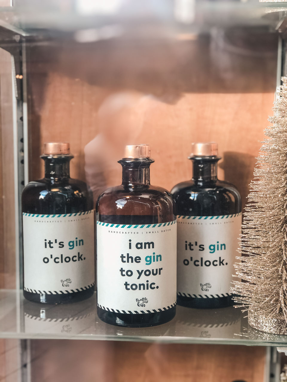Bottles of gin on a glass shelf