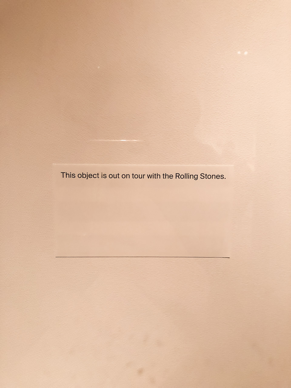 A sign on the wall of The Met that says "This object is out on tour with the Rolling Stones"
