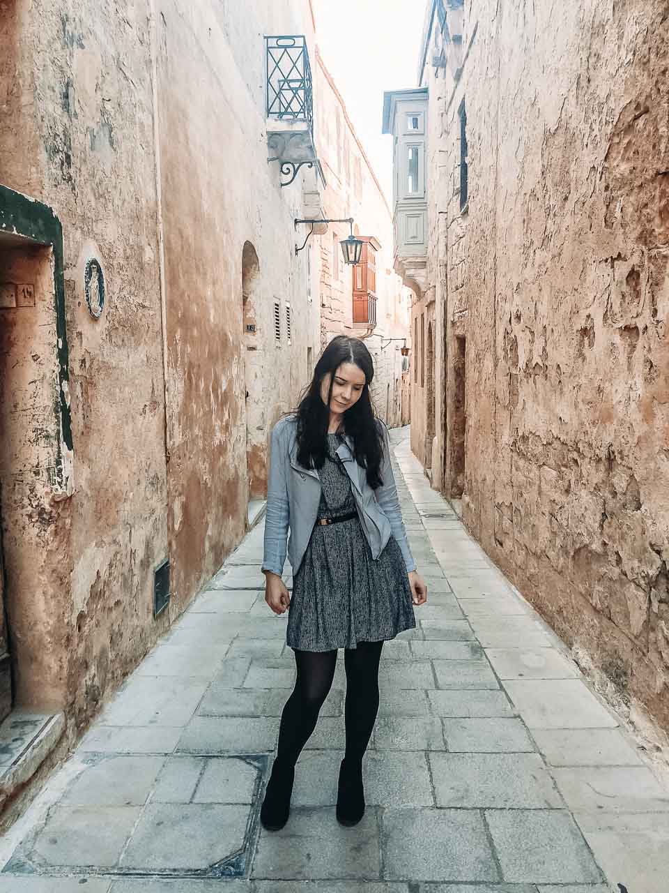 A girl standing in a traditional alley in Mdina, Malta