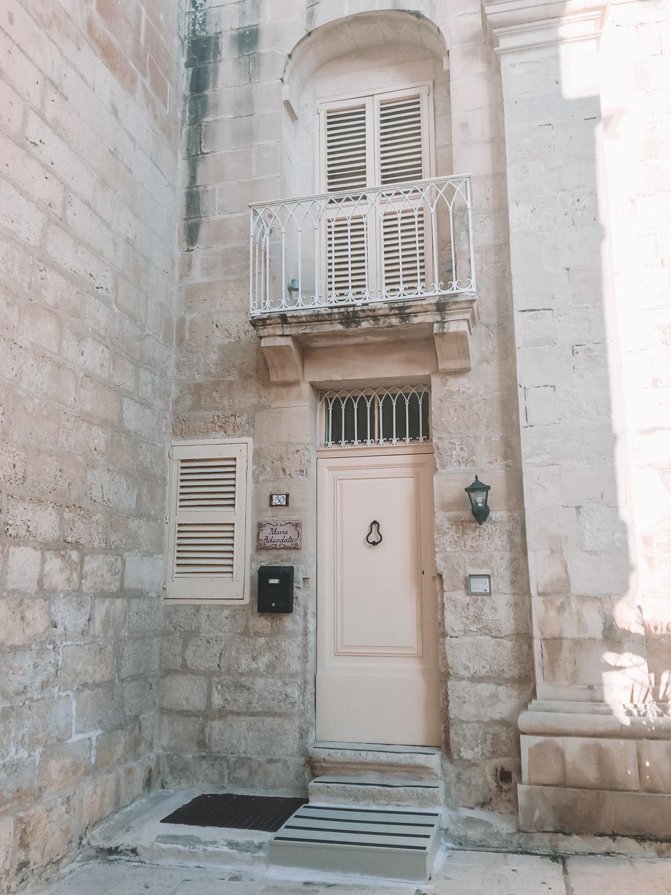 A traditional Maltese house with a patterned tile in Mdina, Malta
