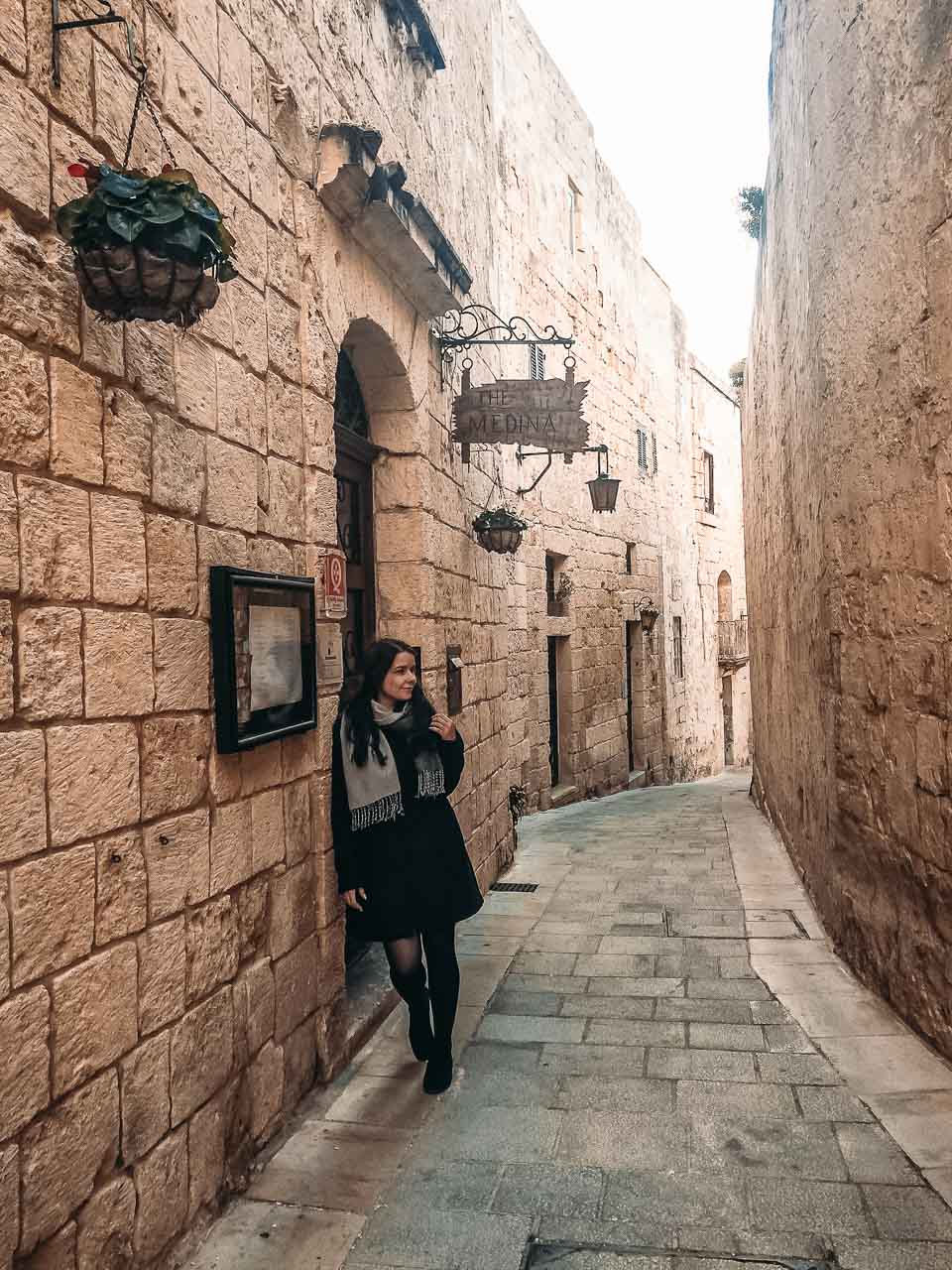 A girl standing in a traditional alley in Mdina, Malta