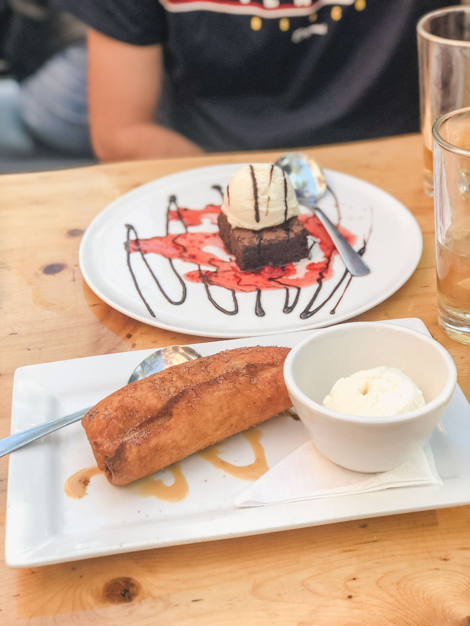 Fried apple pie with ice cream and a brownie with ice cream at Queen St. Warehouse in Toronto