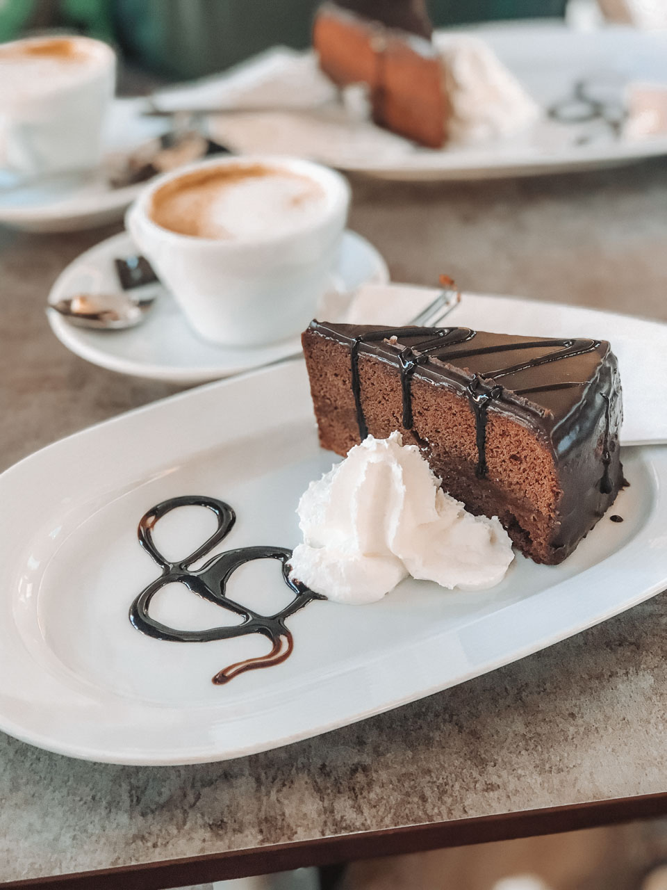 Sachertorte with whipped cream at L'Opera Restaurant & Cafe in Vienna, Austria