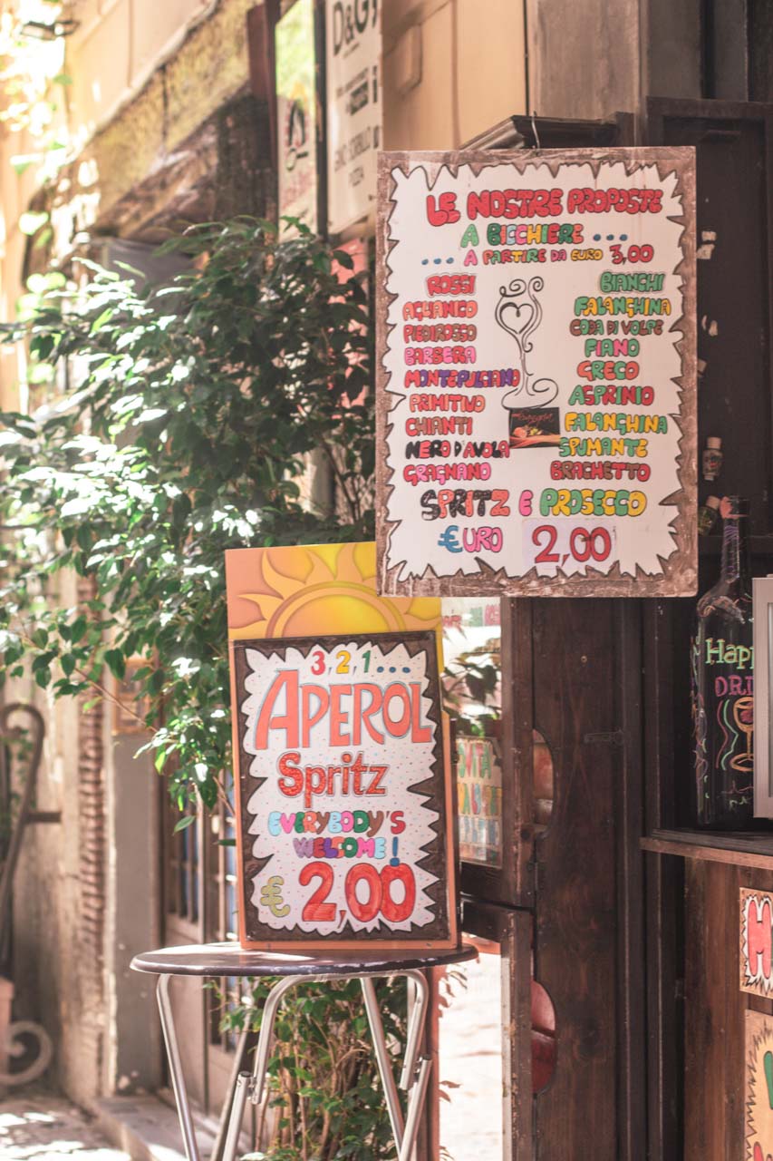 A sign outside a bar advertising Aperol Spritz