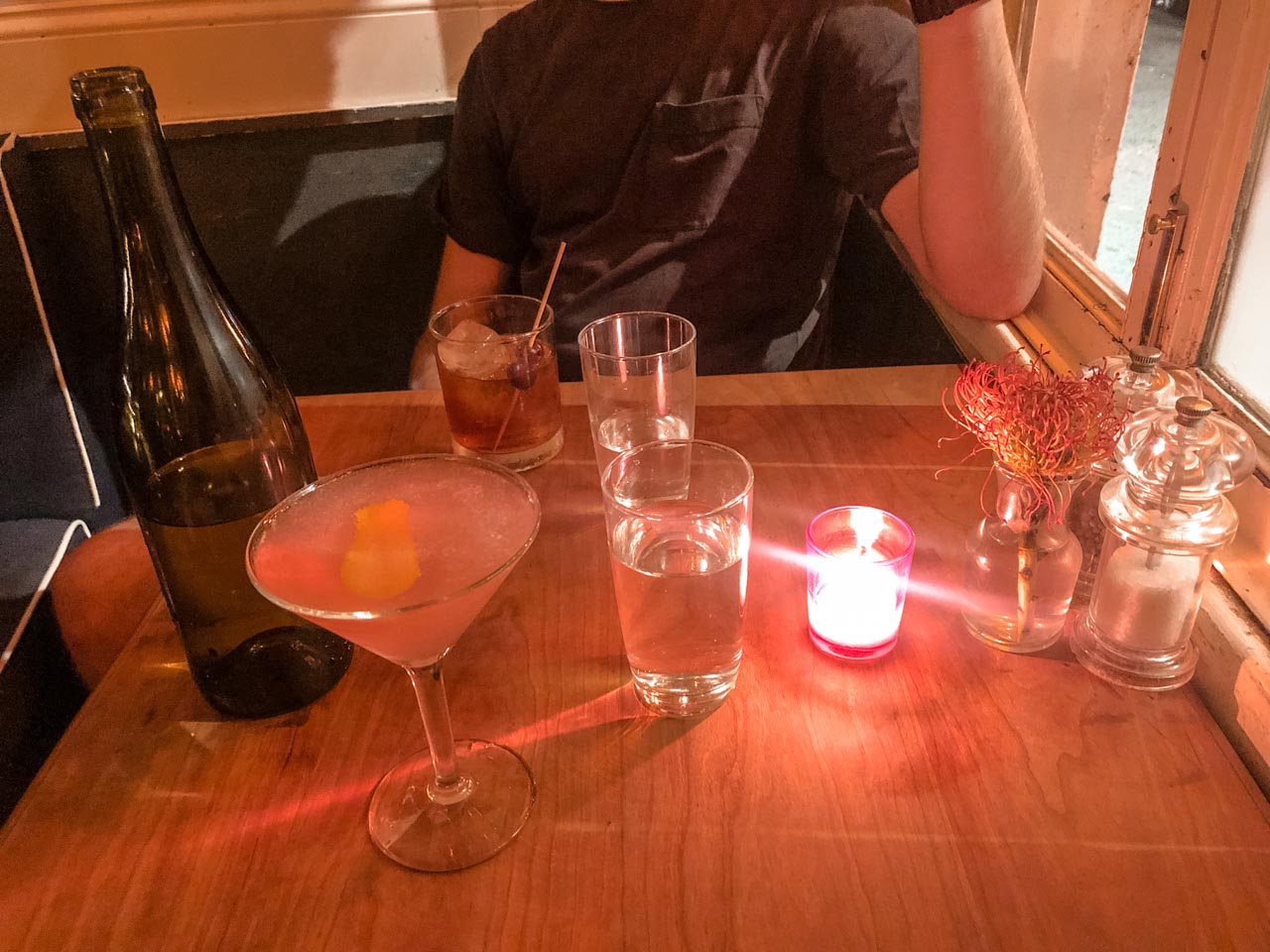 Two cocktails and two glasses of water on a table at Rintintin