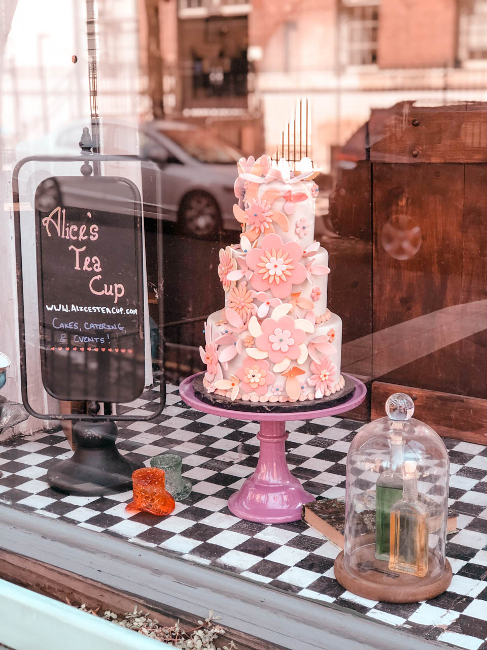 Cake on a stand in the window of Alice's Tea Cup in Brooklyn