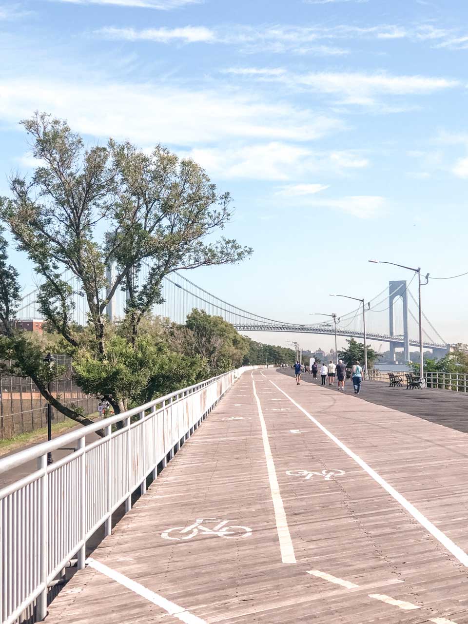 A boardwalk on Staten Island with the Verrazano-Narrows Bridge in the background