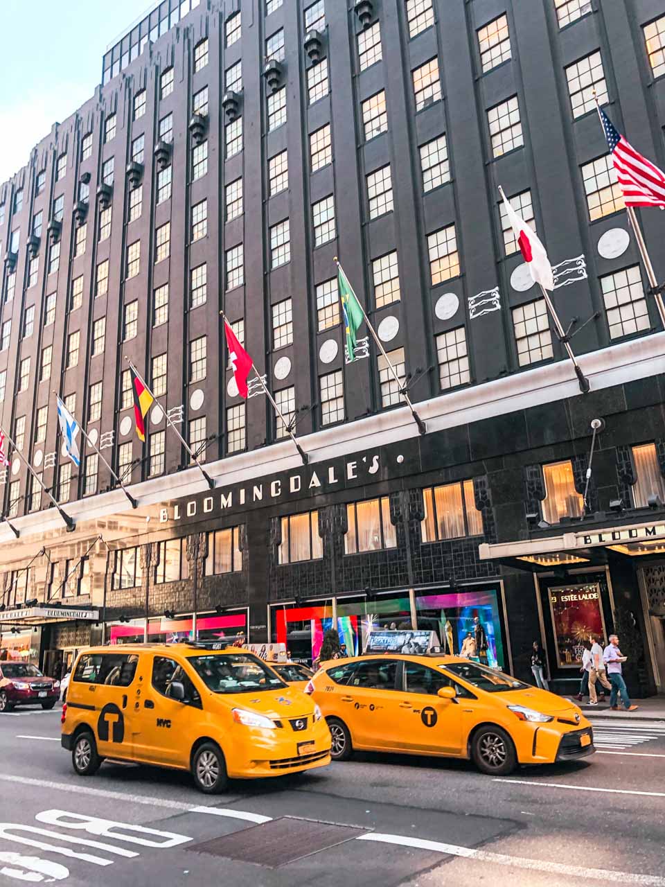 Yellow cabs driving past Bloomingdale's in New York City