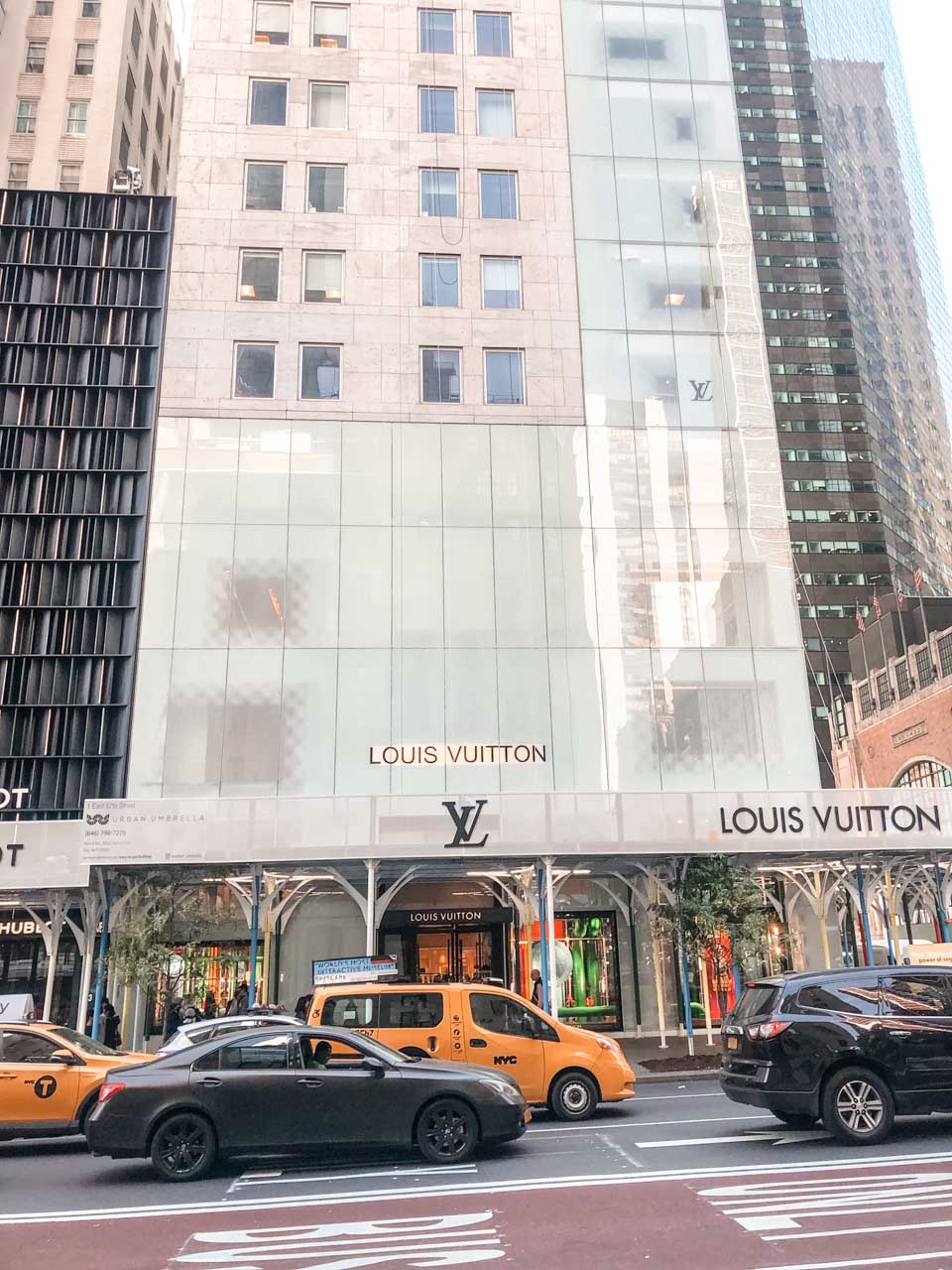 Cars driving past the Louis Vuitton store on Fifth Avenue