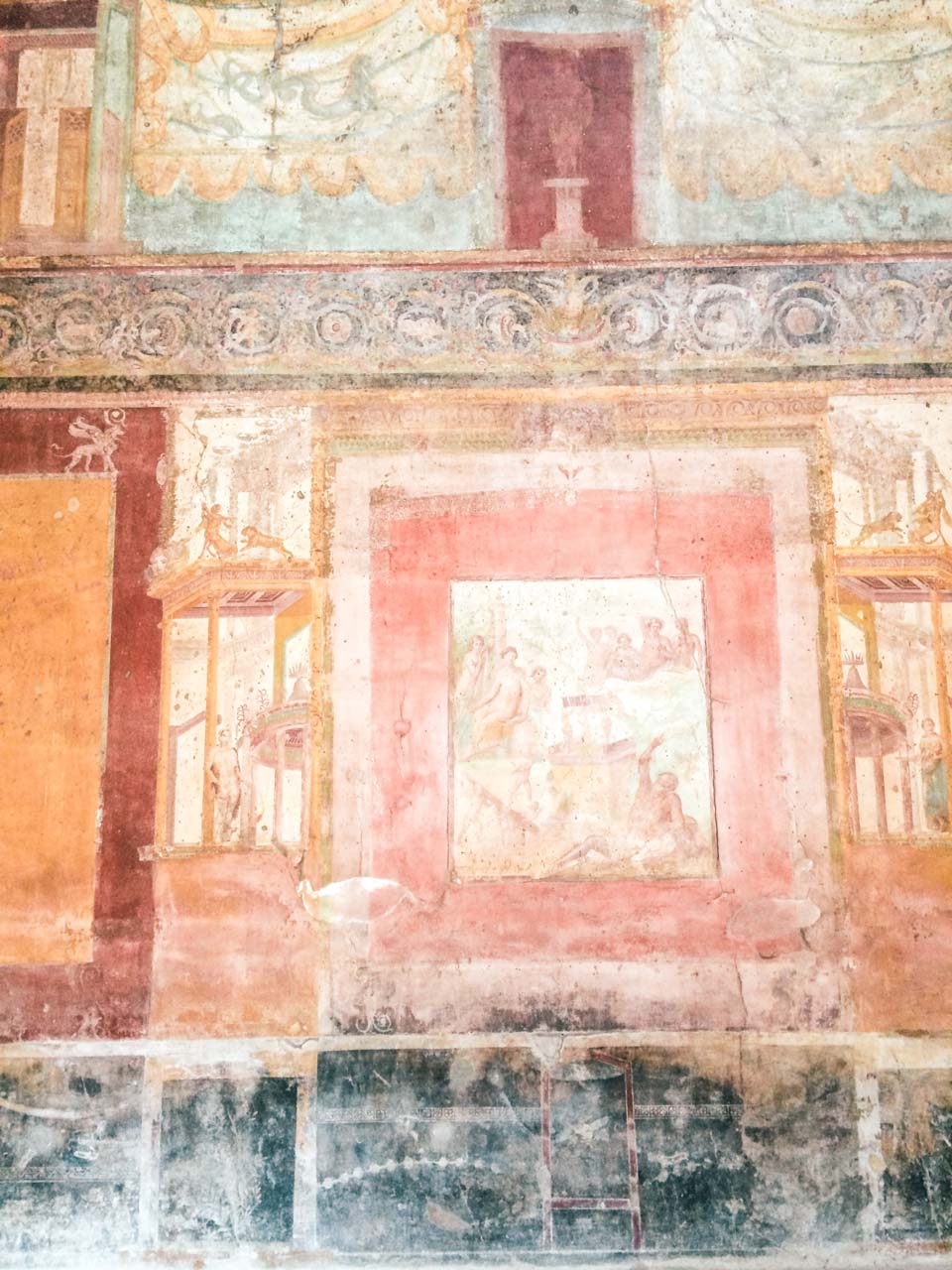 Old colourful paintings on the walls of a building inside Pompeii