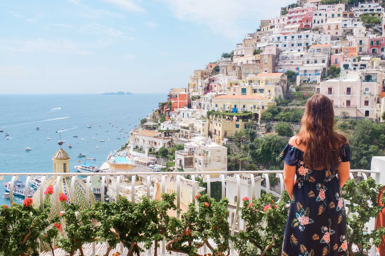 A girl in a floral dress standing on the terrace of Le Sirenuse Hotel in Positano