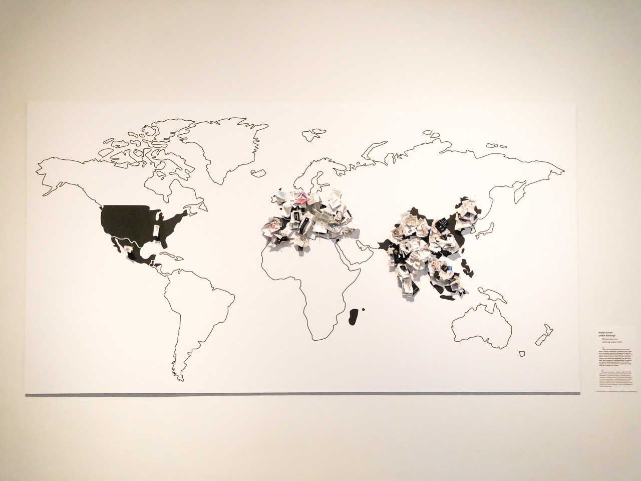 Contour world map with garment labels glued to it inside the Museum of European Cultures in Berlin