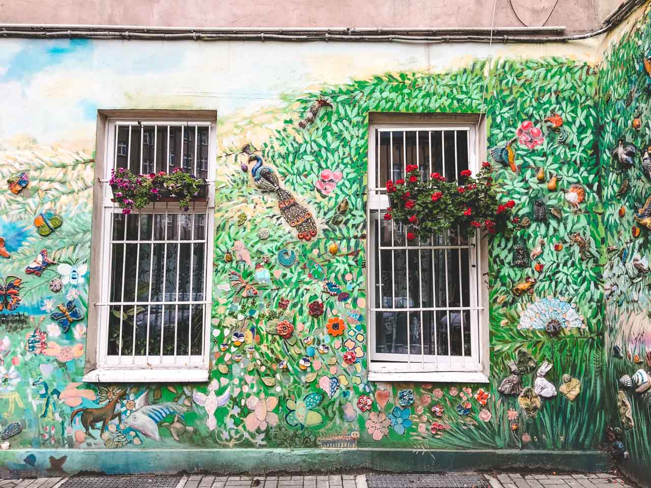 Art installation on the façade of an old tenement house in Wrocław depicting a paradise garden