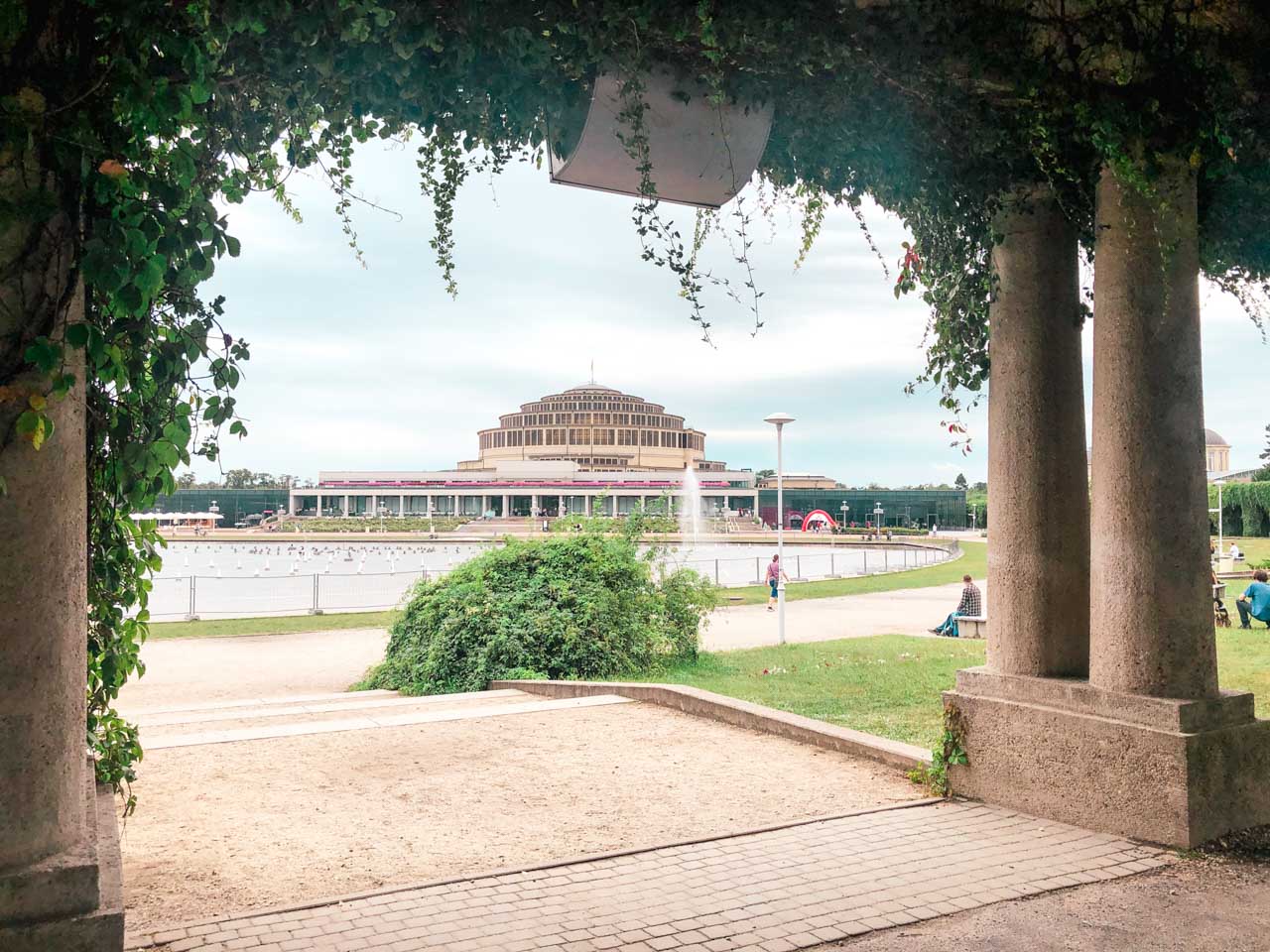 Centennial Hall in Wrocław seen from one of the surrounding ivy-covered pergolas