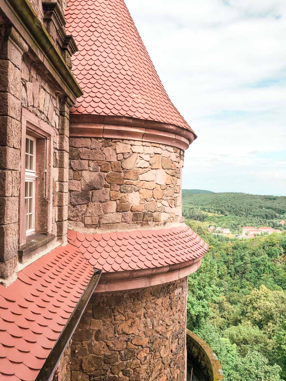 A close-up shot of a tower of Książ Castle seen from one of the rooms