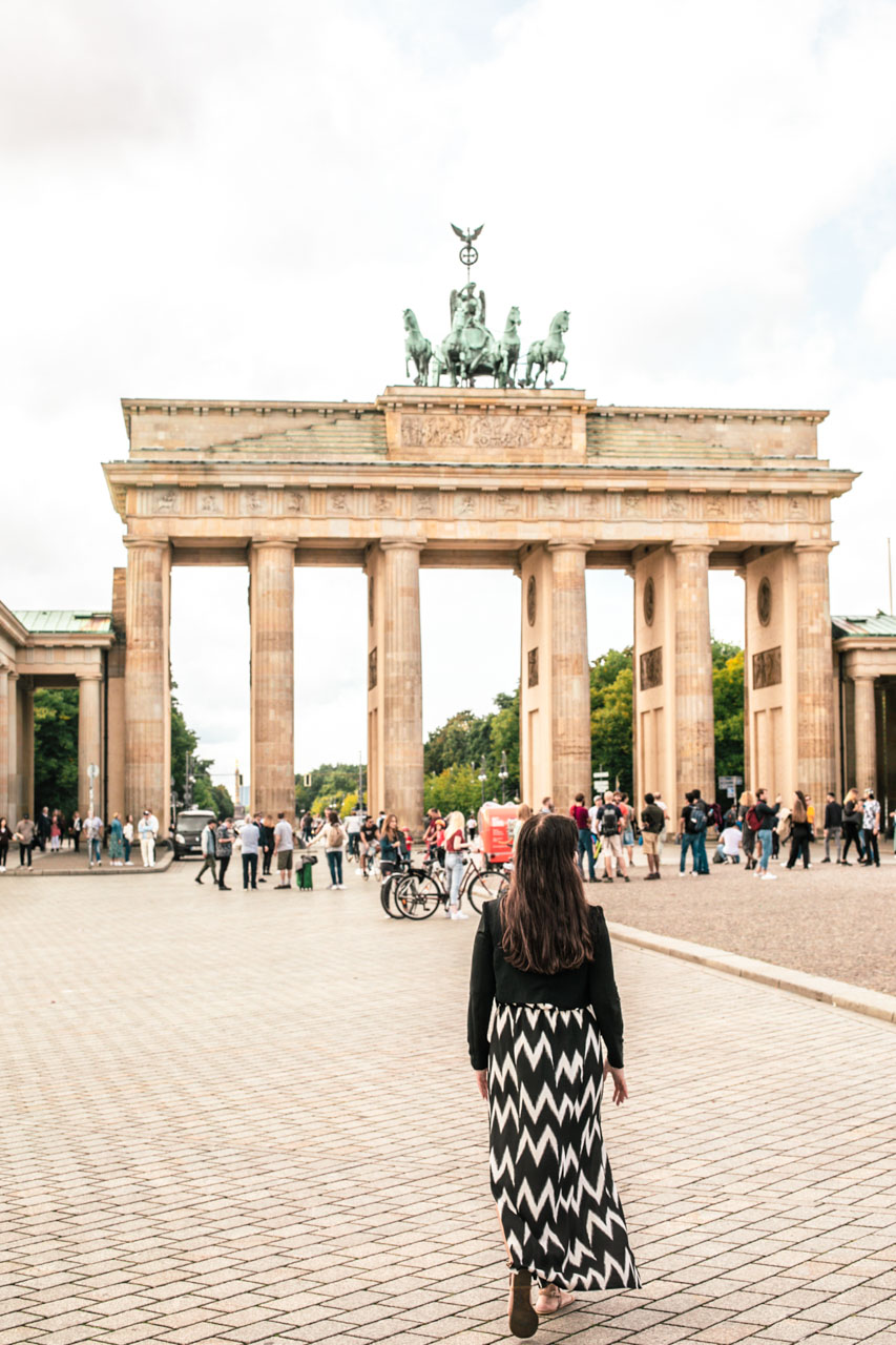 Woman walking towards the Brandenburg Gate in Berlin, Germany