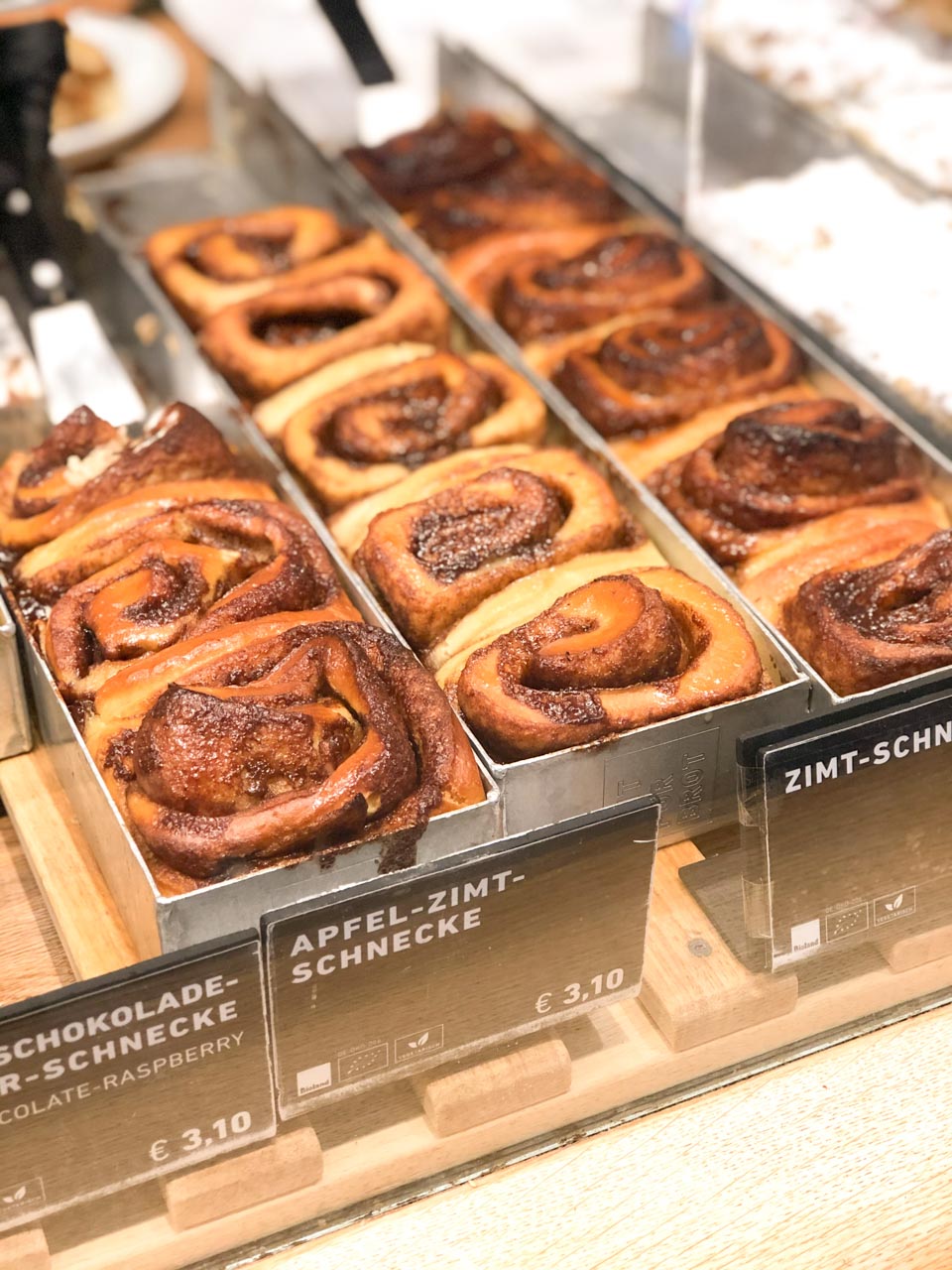 Rows of cinnamon buns behind the counter at Zeit für Brot in Berlin, Germany