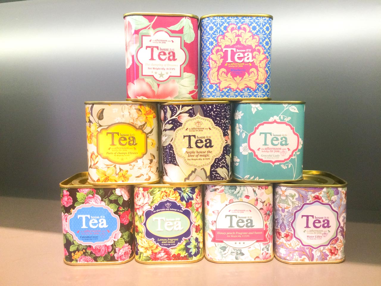 A pyramid made of different flavoured tea tins