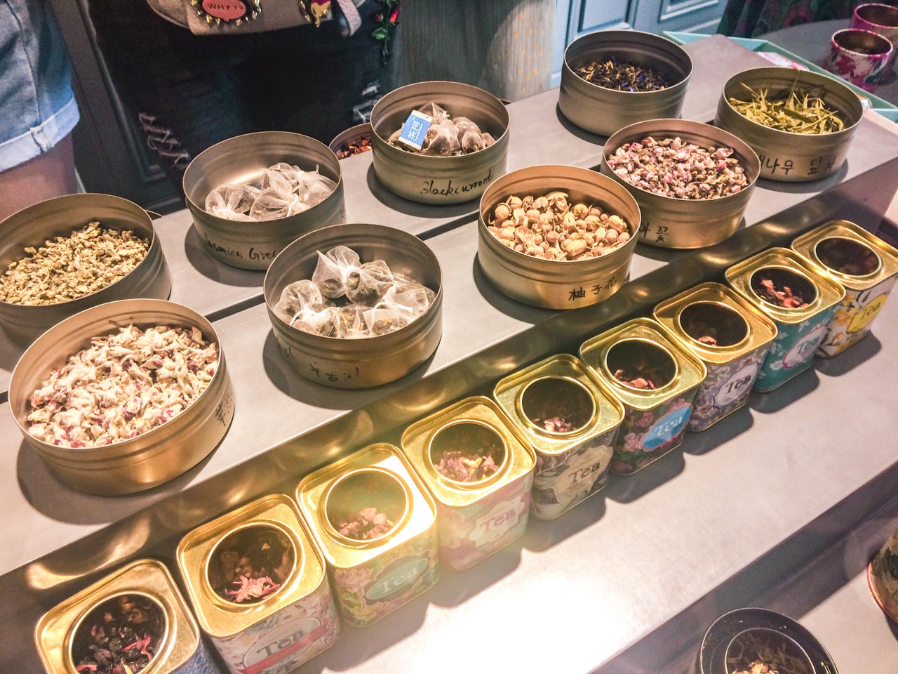 Rows of open tea tins on display at a tea shop in Beijing, China