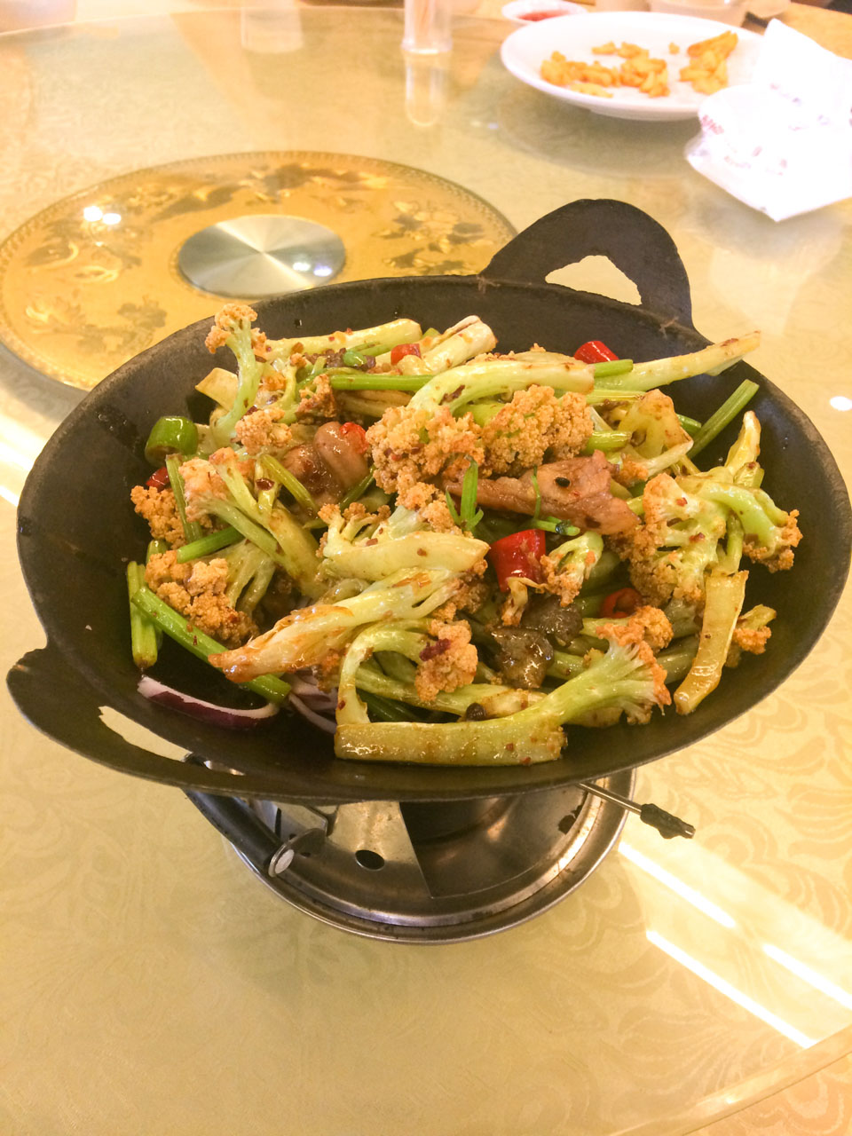 A bowl of Chinese cauliflower on a Lazy Susan rotating table