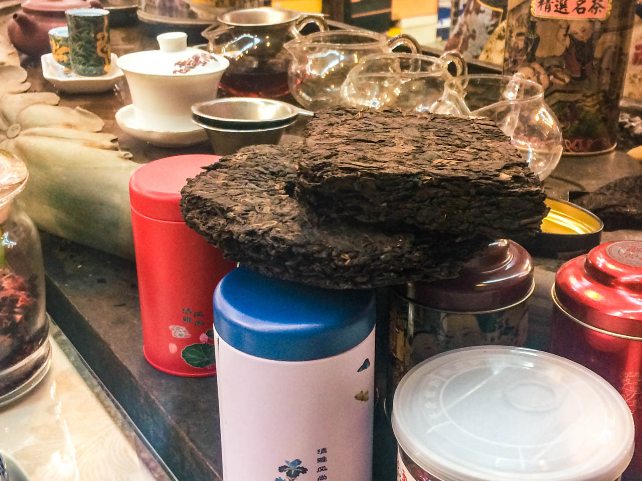 A close-up shot of pressed Pu-erh tea cakes at a traditional Chinese tea shop in Beijing, China