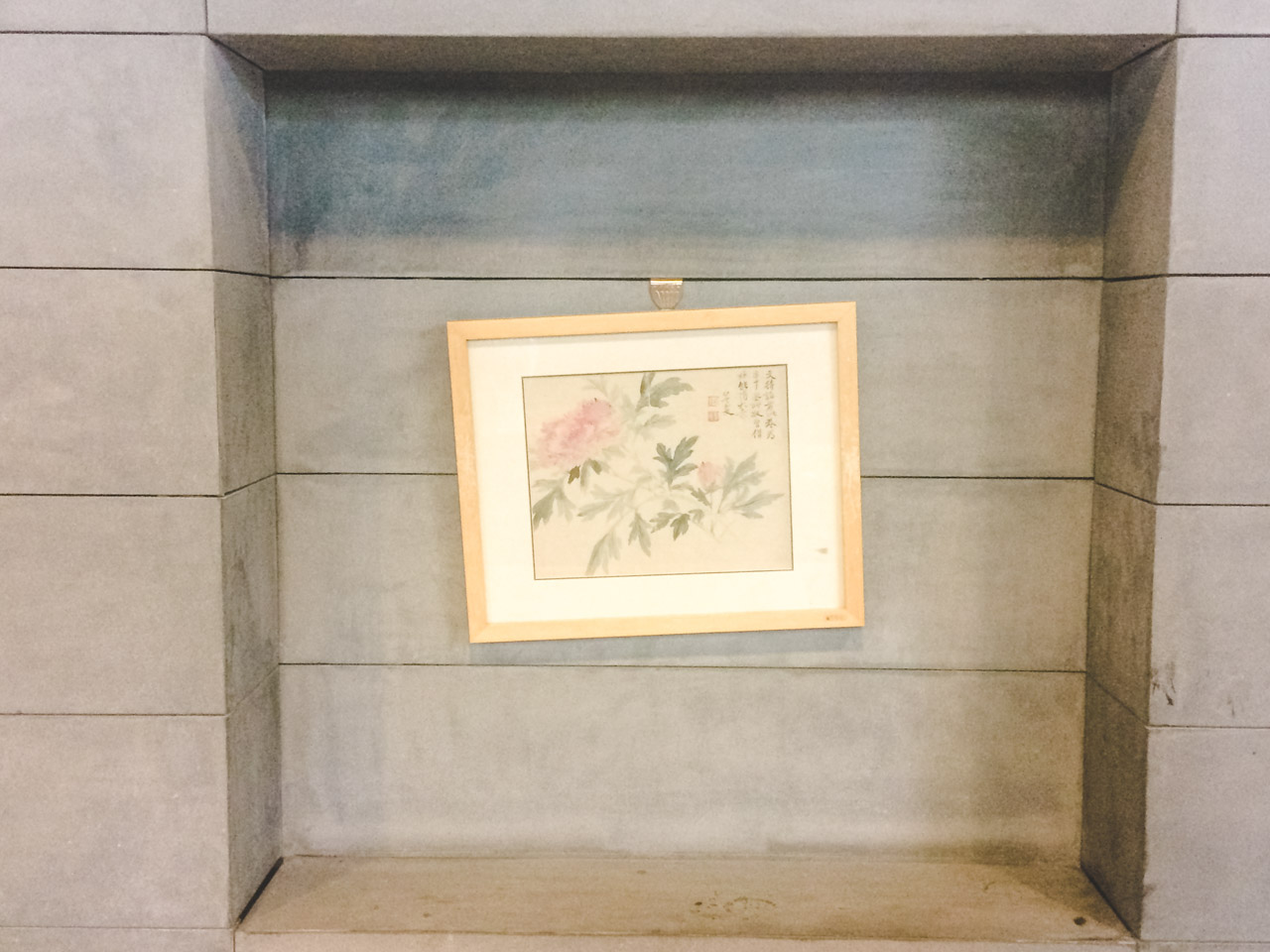 A flower painting hanging on a wall inside a tea room at the Capital Museum in Beijing, China