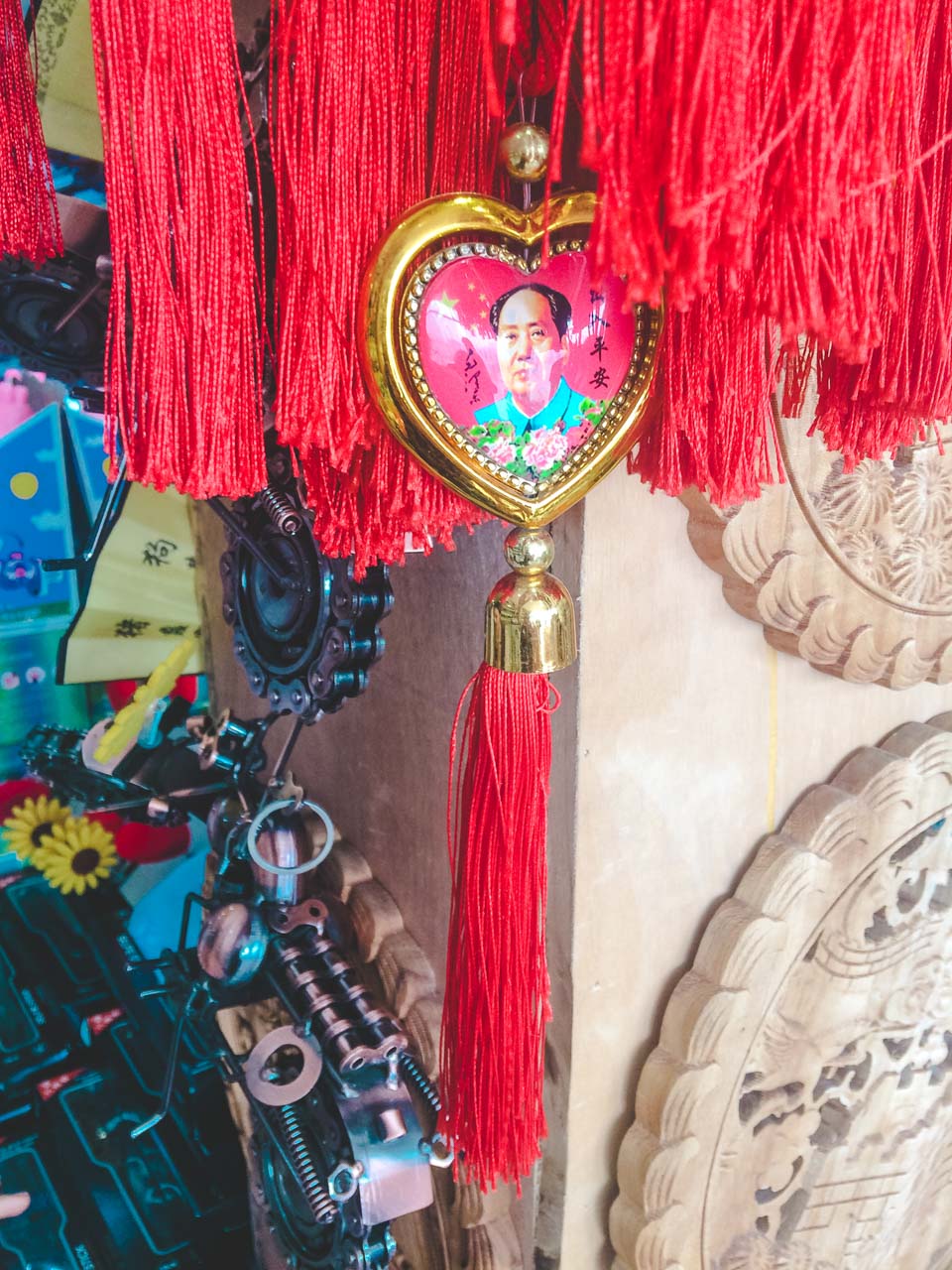 Hanging Chinese tassel with a heart-shaped portrait of Mao Zedong at a souvenir shop in Beijing