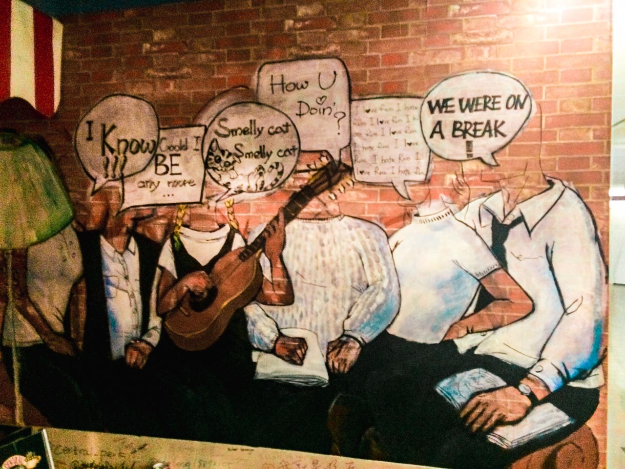 Mural on a brick wall inside the Central Perk café in Beijing, China featuring the main characters