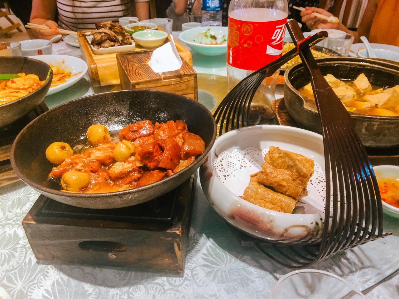 Various Chinese dishes on a Lazy Susan rotating table at a restaurant in Beijing, China
