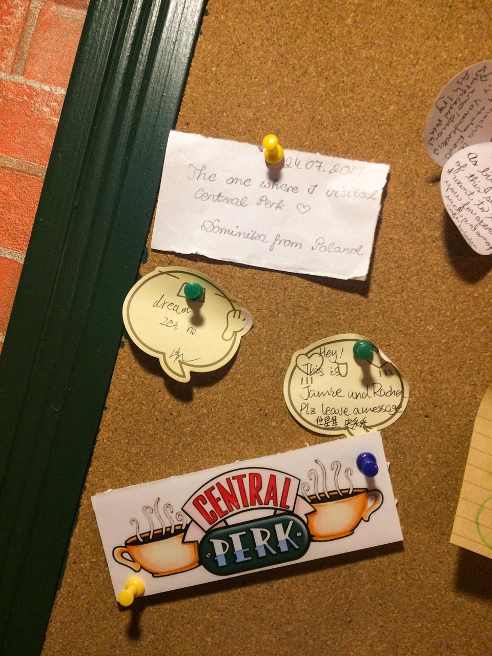 Note saying "The one where I visited Central Perk - Dominika from Poland" pinned to a corkboard