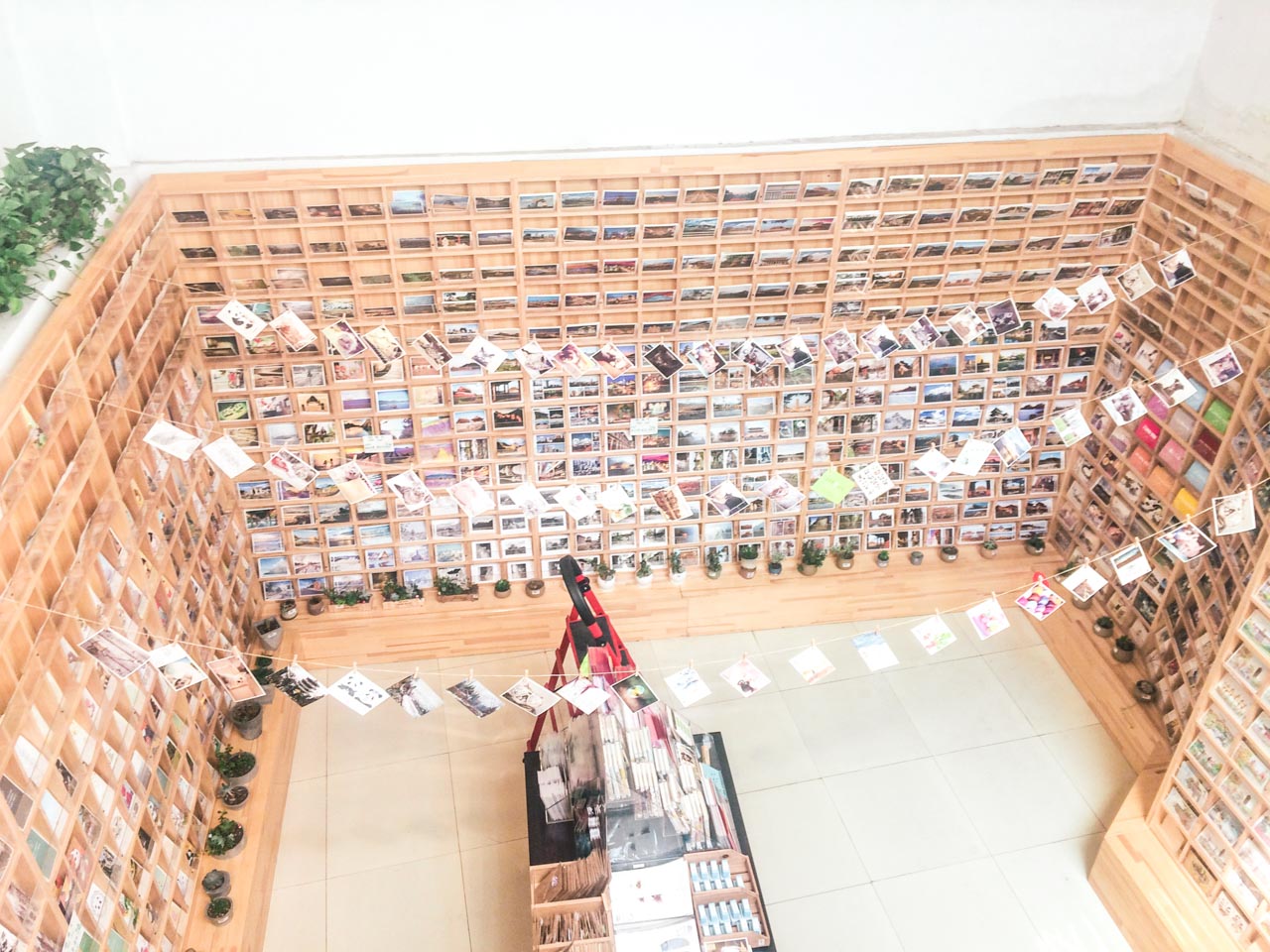 An open-ceiling basement of a souvenir shop in Beijing, China filled with postcards