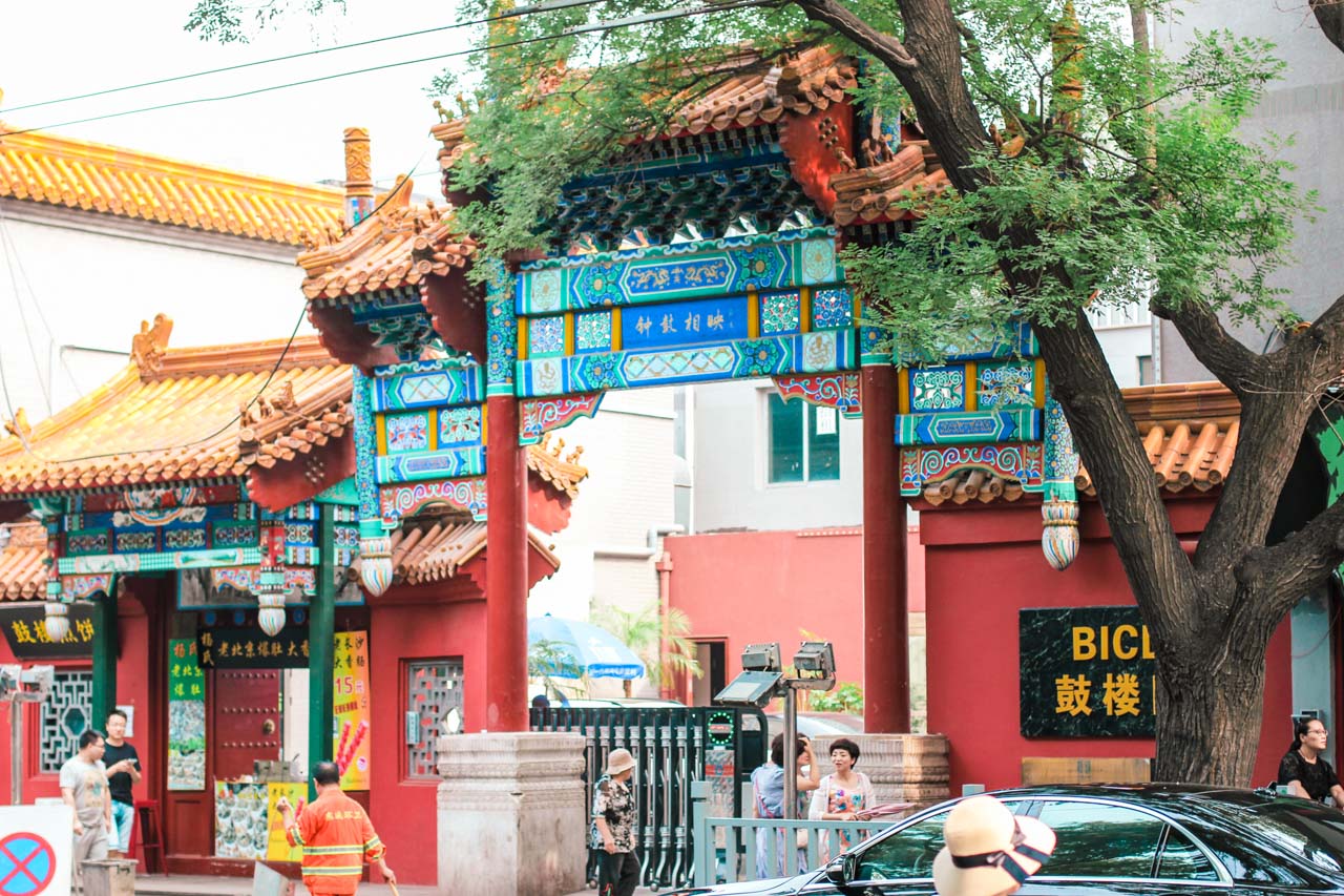 A traditional Chinese gate in a busy street in Beijing, China