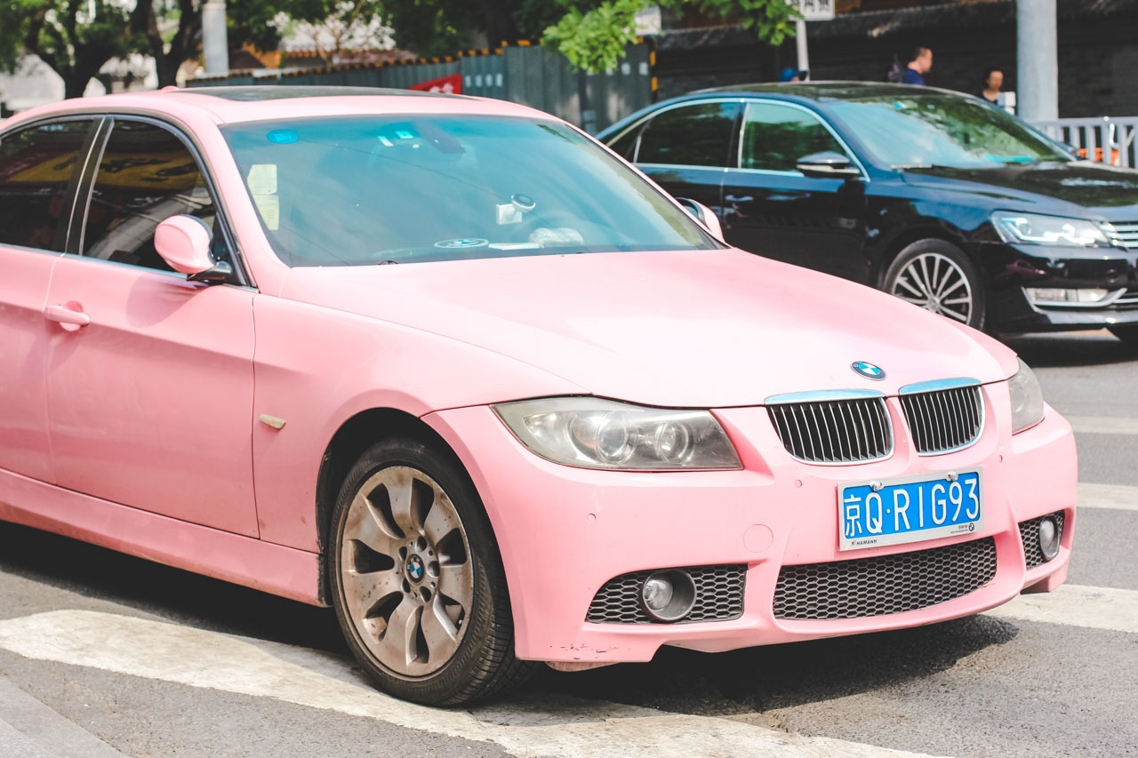 A pastel pink car in a street in Beijing, China