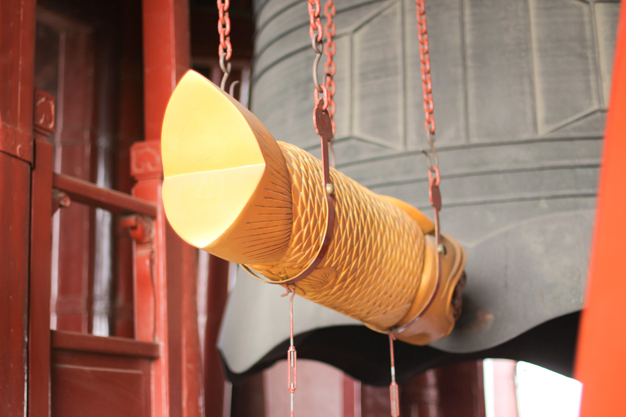 A fish-shaped bell striker on a metal chain at the Drum and Bell Towers in Beijing, China