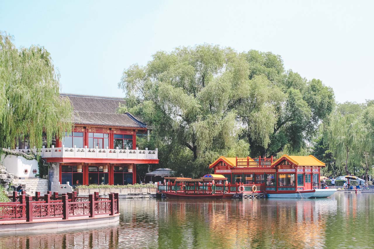 Dragon boats docked on Huohai Lake in Beijing, China, right outside a traditional Chinese building