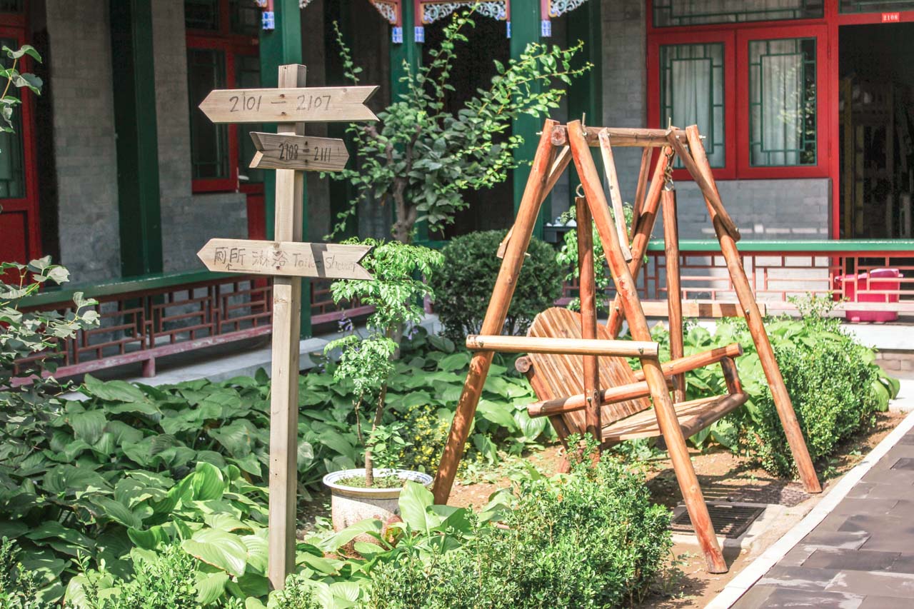 Wooden swing in the outdoor patio area of Beijing Heyuan International Youth Hostel