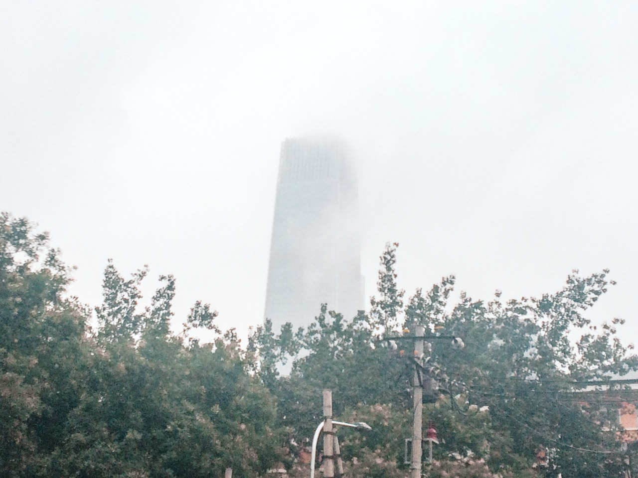 A smog-covered skyscraper in Beijing, China
