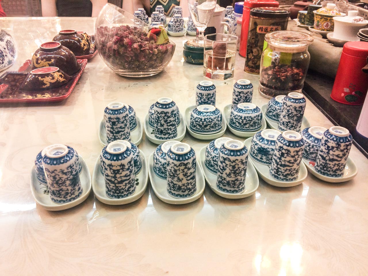 Rows of white and blue tea tasting sets inside a traditional tea house in Beijing, China