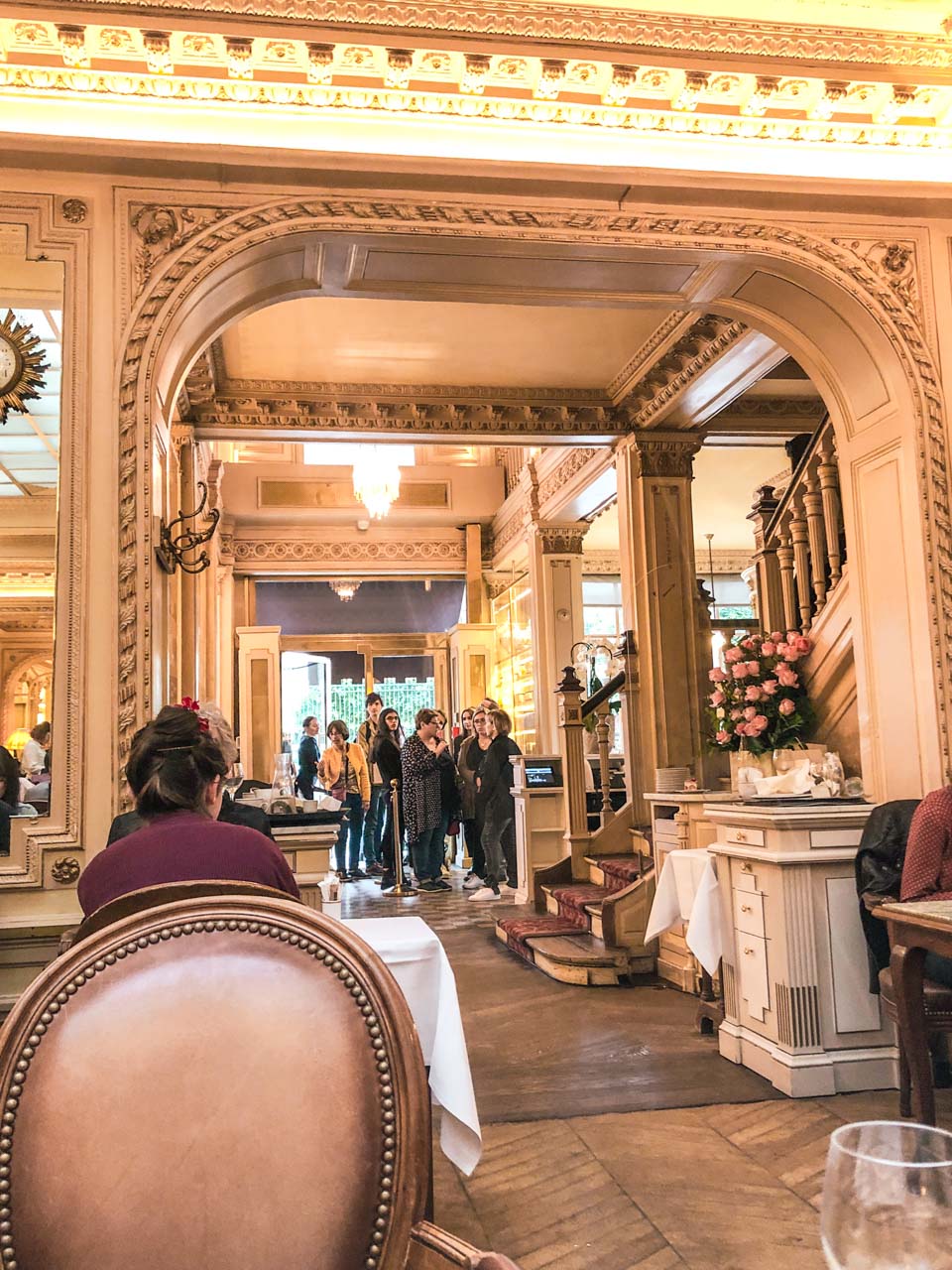 A short queue in the lobby of the Angelina tea house and café at 226 Rue de Rivoli in Paris
