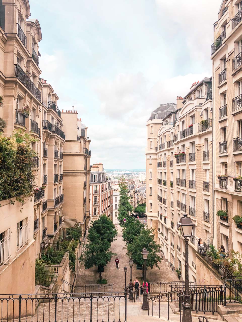 A traditional Parisian street in Montmartre seen from the top of the stairs